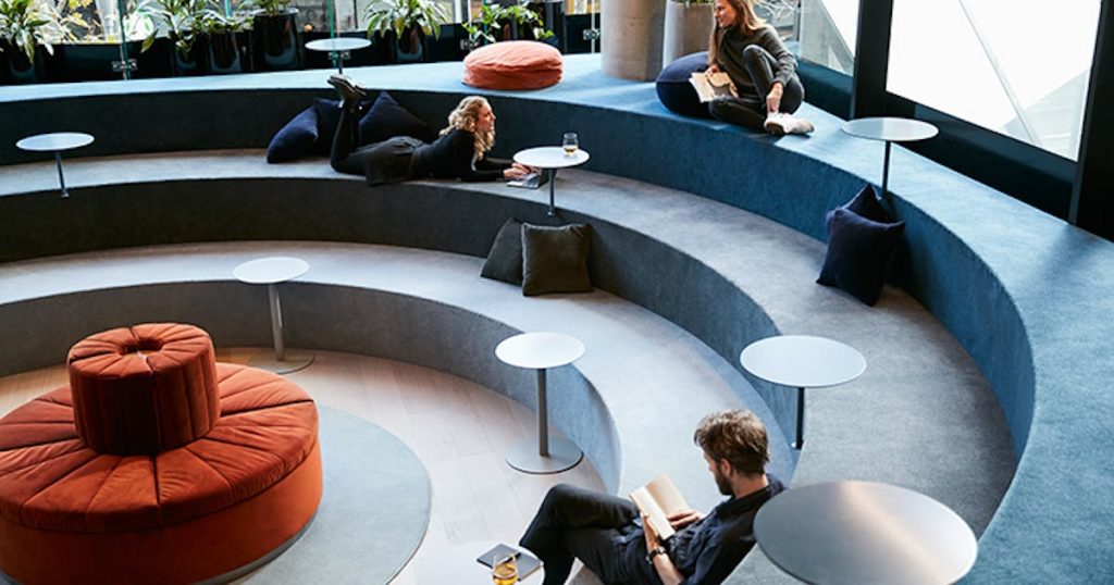A modern co-working spaces with professionals collaborating.