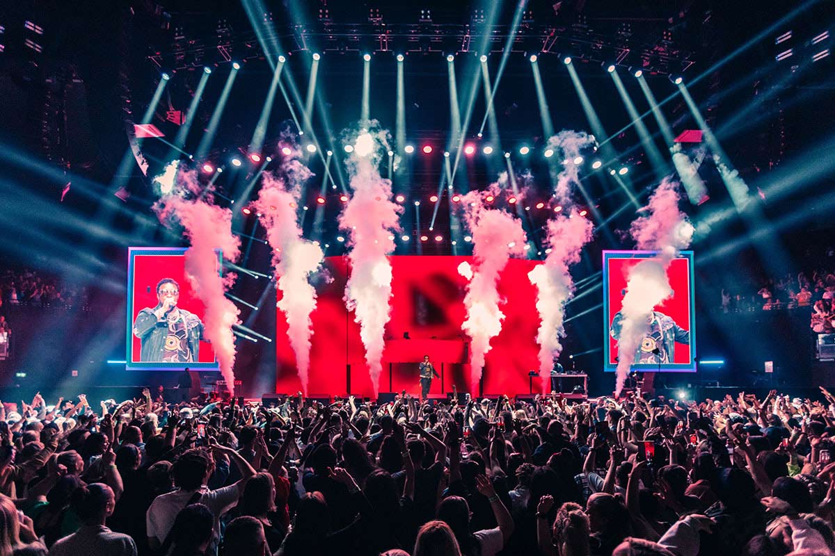 Mariah Carey performing on stage at Fridayz Live Melbourne 2025 with a vibrant crowd at Marvel Stadium.