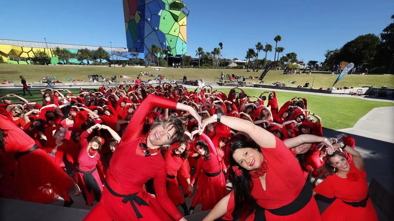 Melbourne crowd dancing in red dresses at The Most Wuthering Heights Day Ever event in Edinburgh Gardens