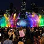 Families enjoying the Crown Christmas River Show with lasers, fountains, and festive lights along the Yarra River in Melbourne