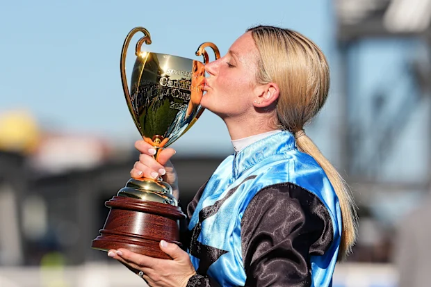 Jamie Melham celebrates her 2025 Melbourne Cup victory aboard Half Yours at Flemington Racecourse, marking a historic moment for Australian racing.